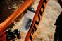 Fidlock-Twist-600ml-attached-to-an-orange-bike-with-black-writing-along-it