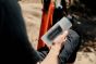 Fidlock-Twist-600ml-outdoors-with-a-bike-in-the-background,-a-man-is-holding-the-bottle
