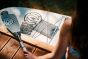 fidlock-dry-bag-mega-fabric-grey-attached-to-a-surfboard