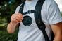 fidlock-lens-cap-clip-being-attached-to-bag-strap